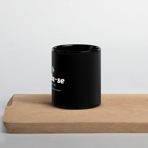 May include: Black ceramic coffee mug with a white graphic that says "Fala-se" with a small green and yellow Brazilian flag icon. The text below the graphic says "[verb] / [noun] / to speak; that which is better."