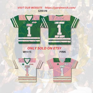 May include: Green, white, and pink jerseys with the text "IVIES" and the number "1". The jerseys have a V-neck design and striped sleeves. The image also includes the text "VISIT OUR WEBSITE https://yardmerch.com/" and "ONLY SOLD ON ETSY".