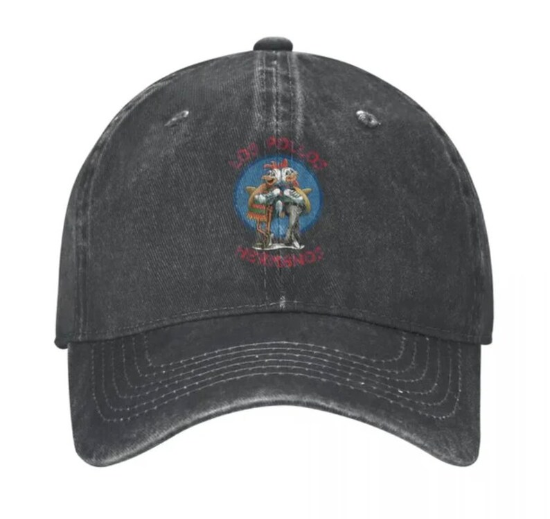 May include: A black distressed denim baseball cap with a vintage-style logo featuring two cartoon chickens holding fish and the text "Los Pollos Hermanos".