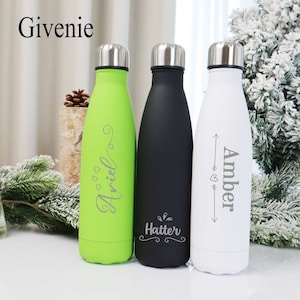 May include: Three stainless steel water bottles with personalized names. The bottles are green, black, and white. The names are "Hattie", "Amiel", and "Amber".