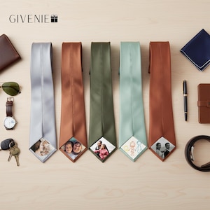 May include: Five neckties in light gray, copper, olive green, sage green, and rust orange, each featuring a custom square photo or drawing printed on the bottom tip. The brand name GIVENIE with a gift box icon is visible in the top left corner.
