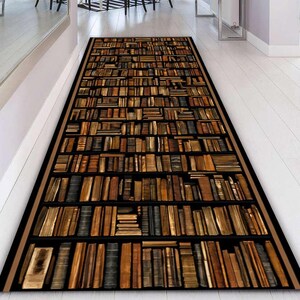May include: A rectangular rug featuring a bookshelf design. The rug displays rows of books in various shades of brown, tan, and black, creating a realistic library aesthetic. The rug has a black border with a thin tan trim.