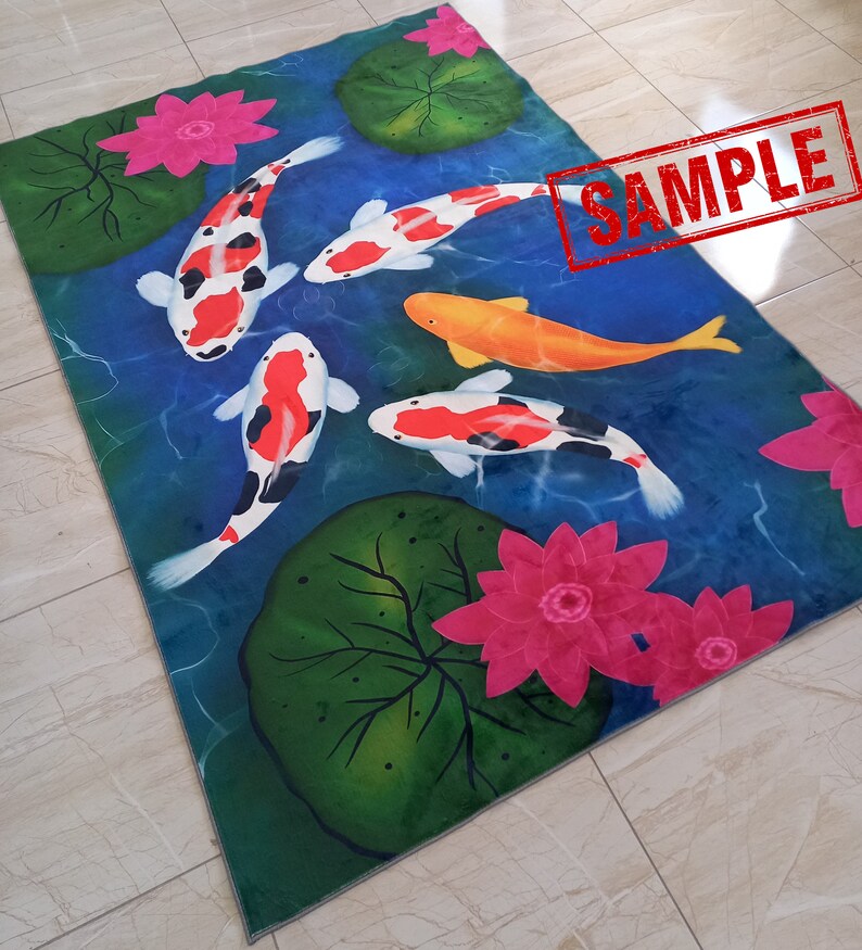 May include: Rectangular rug featuring a pond scene with koi fish, lily pads, and lotus flowers. The koi fish are white, orange, and black, swimming in blue water. Pink lotus flowers and green lily pads are scattered around the pond.