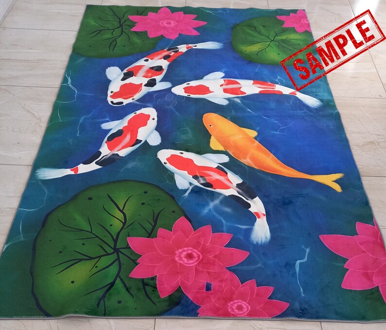 May include: A rectangular rug featuring a pond scene with koi fish, water lilies, and lotus flowers. The koi fish are orange, white, and black, swimming in blue water. Pink lotus flowers and green lily pads are scattered around the pond.