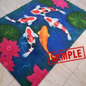 May include: A rectangular rug featuring a pond scene with koi fish and water lilies. The koi fish are orange, white, and black, swimming in blue water. Pink water lilies and green lily pads are also present. The word "SAMPLE" is stamped on the rug.
