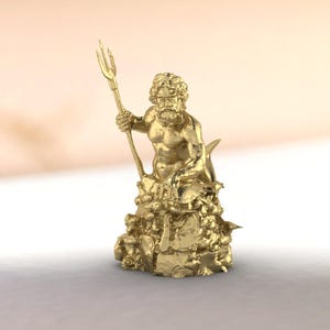 Small King Neptune figure in golden brass, detailed facial features and muscular torso, decorative coral base with fish and sea creatures