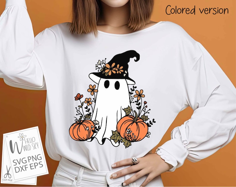 May include: White t-shirt with a ghost wearing a witch hat and surrounded by orange pumpkins and flowers. The text "Hello Wild Sky" is on a separate card.