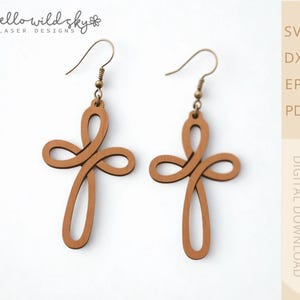 May include: A pair of wooden cross earrings with a light brown finish. The earrings feature a looped design and are suspended from gold-colored ear wires. The image also includes the text "hello wild sky laser designs" and "DIGITAL DOWNLOAD".