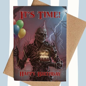 May include: Birthday card with a skeletal figure holding a cake and balloons. The card reads "IT'S TIME!" and "HAPPY BIRTHDAY" in red. The background depicts a dark forest with lightning. The card is on a brown envelope.