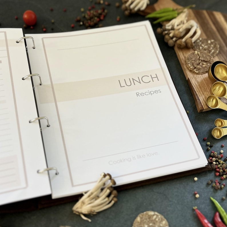 Personalized custom ring binder recipe book with hard cover and printed pages. Features recipe journal pages with sections for recipe name, prep time, cook time, servings, ingredients, directions, and notes. Includes 16 category dividers, 10 notes pages, 20 transparent sleeves, and one clear envelope sheet for small notes. Perfect for saving cherished meals, holiday dishes, and family traditions — a thoughtful gift for home cooks who love sharing meals together.