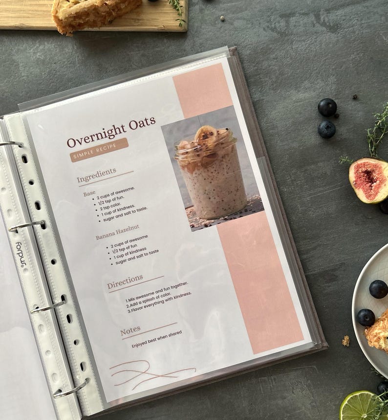 Personalized custom ring binder recipe book with hard cover and printed pages. Features recipe journal pages with sections for recipe name, prep time, cook time, servings, ingredients, directions, and notes. Includes 16 category dividers, 10 notes pages, 20 transparent sleeves, and one clear envelope sheet for small notes. Perfect for saving cherished meals, holiday dishes, and family traditions — a thoughtful gift for home cooks who love sharing meals together.