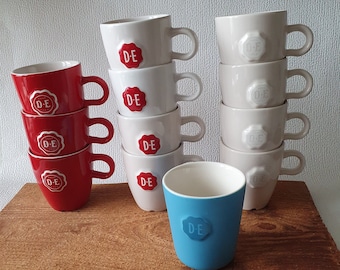 Douwe Egberts Holland red, white and blue coffee mugs with the (red) Douwe Egberts brand seal embossed, design by Nikolai Carels