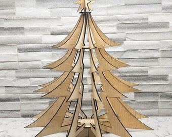 May include: A wooden Christmas tree ornament with a star on top. The tree is made of multiple layers of wood and has a light brown color.