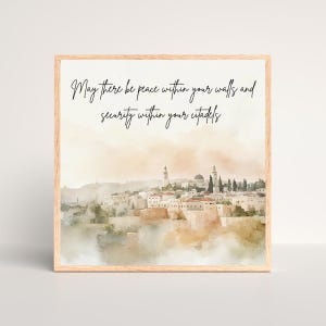 May include: A framed watercolour print depicting a cityscape, with a light brown wooden frame. The artwork uses a soft, muted colour palette and features a quote in elegant script: "May there be peace within your walls and security within your citadels."