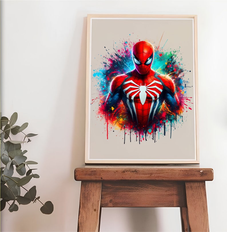 Puede incluir: Una impresi&oacute;n de arte digital que presenta a un superh&eacute;roe con un traje rojo y azul con un logotipo de ara&ntilde;a. El fondo es una salpicadura de pintura colorida.