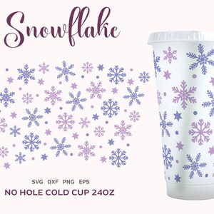 May include: A white 24 ounce cold cup with a no hole lid. The cup is decorated with a pattern of purple and blue snowflakes and stars.