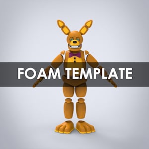 May include: A brown and yellow animatronic figure with a bow tie and ears. The figure is made up of separate pieces, suggesting it is a foam template.