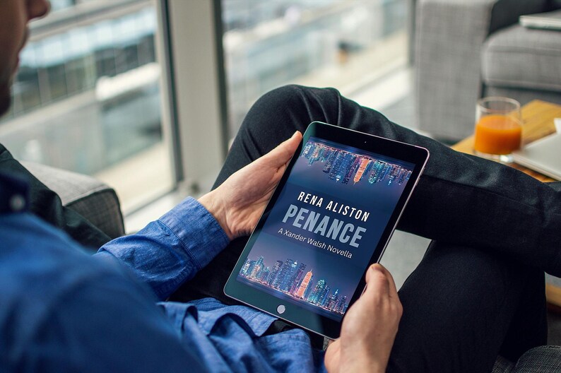 May include: A person holding a tablet displaying the book cover for "Penance" by Rena Aliston. The cover features a cityscape with a dark blue background. The person is wearing a blue shirt and black pants.