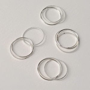 Interwoven silver stacking ring made of three 1mm bands, each with a different texture, ideal for subtle detail and layered styling.