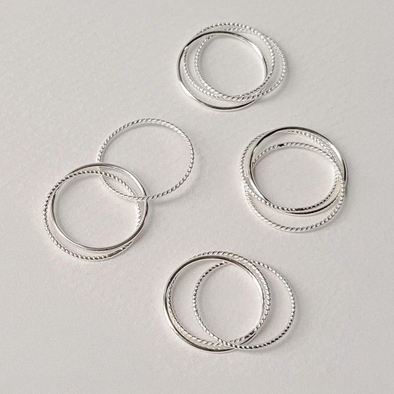 Interwoven silver stacking ring made of three 1mm bands, each with a different texture, ideal for subtle detail and layered styling.