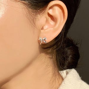 Delicate silver bow earrings for women