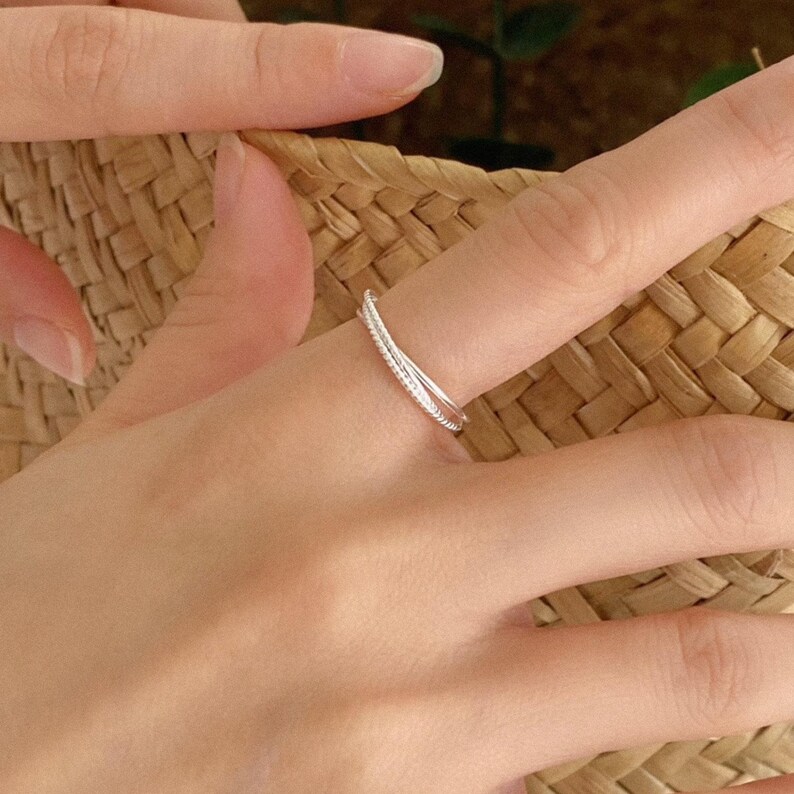 Trio of textured sterling silver bands joined in one timeless piece, ideal for stacking or subtle standalone styling.