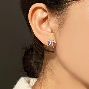 Feminine bow design silver earrings