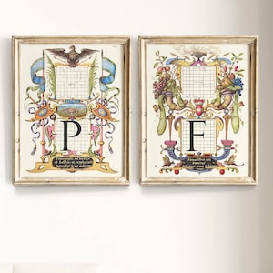 May include: Two vintage framed prints with ornate floral and animal designs. The prints feature the letters "P" and "F" in a decorative font. The frames are a light wood color.