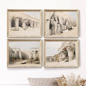May include: A set of four framed prints depicting ancient Egyptian architecture. The prints feature detailed illustrations of columns, statues, and hieroglyphics.