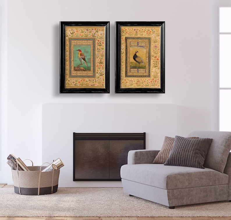 May include: Two framed prints of birds with intricate floral borders. The prints are in black frames with gold accents. The birds are depicted in a traditional style with vibrant colors.