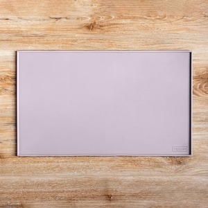 May include: A light purple silicone placemat with the word "FROGUE" in white lettering in the bottom right corner.