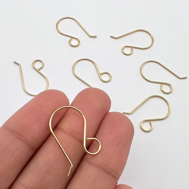 May include: Gold-toned earring hooks, also known as French ear wires, are a popular choice for jewelry making. These hooks are made of metal and have a smooth, polished finish.