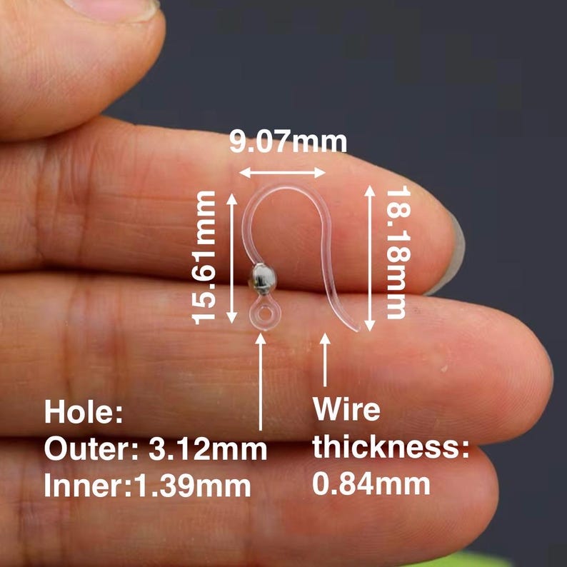 May include: Clear plastic earring hooks with a silver bead and measurements. The hook is 0.84mm thick, 15.61mm long, and 9.07mm wide. The outer hole diameter is 3.12mm, and the inner hole diameter is 1.39mm. The total length is 18.18mm.