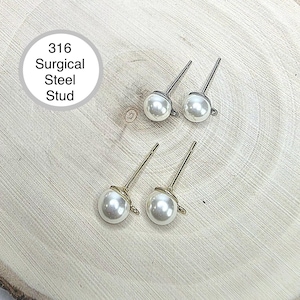 May include: Two pairs of stud earrings featuring white spherical pearls. One pair has silver-toned posts and the other has gold-toned posts. Each earring includes a small loop at the base. Text in the image reads: 316 Surgical Steel Stud.