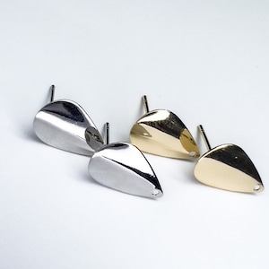 May include: Two pairs of earring backs, one pair is silver and the other is gold. The earring backs are shaped like a teardrop.