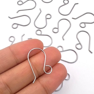 May include: Silver-toned earring hooks, also known as French hooks, are a popular choice for jewelry making. These hooks are made of metal and have a smooth, polished finish. They are designed to be durable and easy to use.