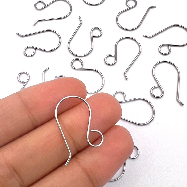 May include: Silver-toned earring hooks, also known as French hooks, are a popular choice for jewelry making. These hooks are made of metal and have a smooth, polished finish. They are designed to be durable and easy to use.