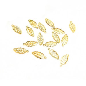 May include: A scattering of 16 gold leaf charms, each with a delicate, intricate design. The charms are perfect for adding a touch of elegance to jewelry making projects.