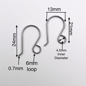 May include: Two silver earring hooks with a 24 mm length, 13 mm width, and 6 mm loop. The inner diameter of the hook is 4.5 mm. The hook is 0.7 mm thick.