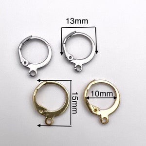 May include: Two pairs of earring findings, one pair is silver and the other is gold. The silver findings are 13mm in diameter and the gold findings are 10mm in diameter and 15mm in length.