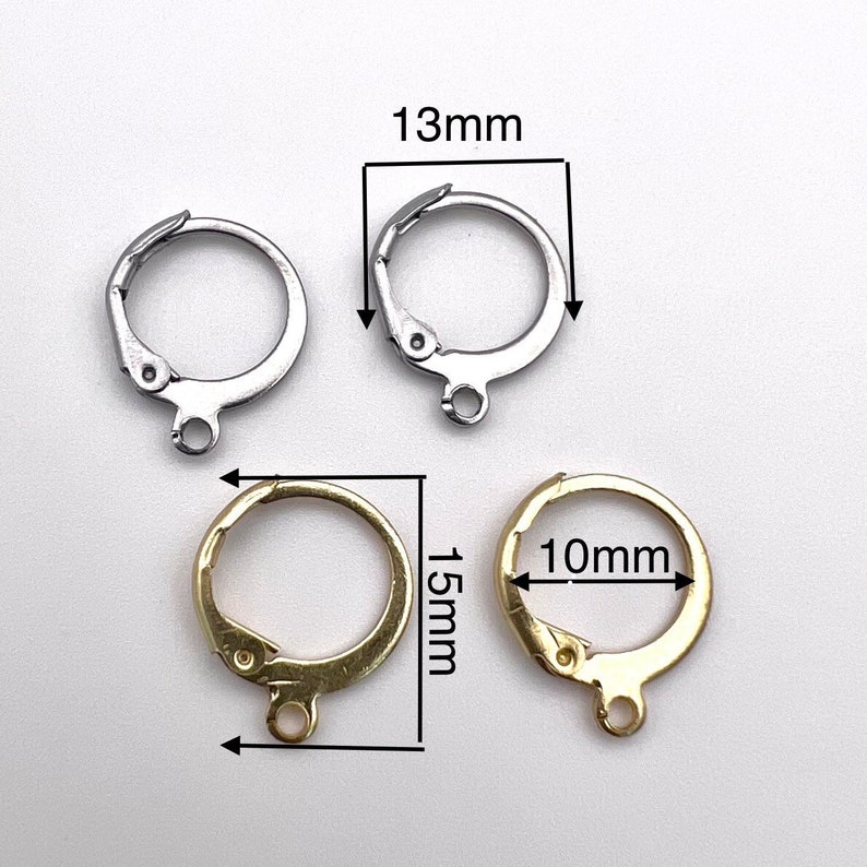 May include: Two pairs of earring findings, one pair is silver and the other is gold. The silver findings are 13mm in diameter and the gold findings are 10mm in diameter and 15mm in length.