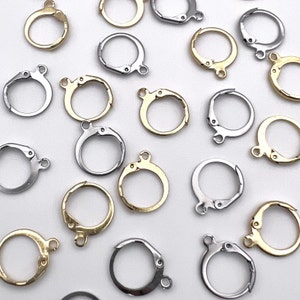 May include: Assortment of silver and gold jump rings, a type of jewelry finding used for connecting jewelry components.