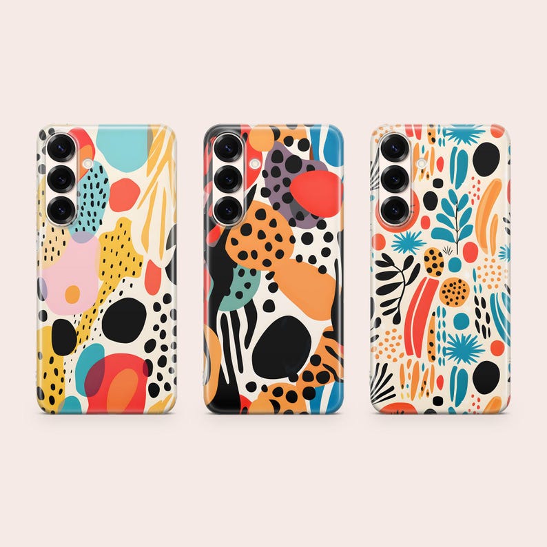 May include: Three smartphone cases featuring abstract patterns with colorful shapes including black dots, red circles, orange blobs, and blue foliage motifs. Each case has a vertical camera cutout on the left side with three circular lenses visible.