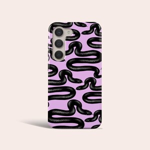 May include: A purple phone case with a black snake pattern. The case has a camera cutout and a black snake pattern.