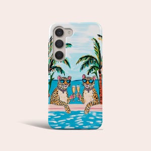 May include: A phone case with a colorful illustration of two leopards wearing sunglasses and drinking champagne in a pool. Palm trees and a blue sky are in the background.