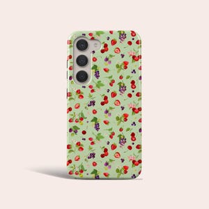 May include: A green phone case with a pattern of red strawberries, blackberries, and green leaves.