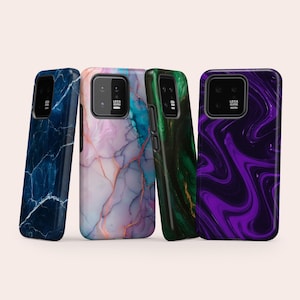 May include: Four smartphone cases featuring distinct patterns: a dark blue marble design, a light pink and blue marbled effect, a deep green with gold veining, and a vibrant purple and black swirl pattern. Each case has a black camera cutout with Leica text.