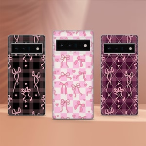 May include: Three phone cases with different patterns. The first case is black and white with pink bows. The second case is pink and white with pink bows. The third case is purple and white with pink bows.
