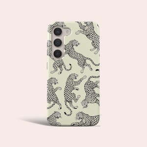 May include: A phone case with a beige background and a black and white leopard print pattern. The case has a camera cutout and a black border.