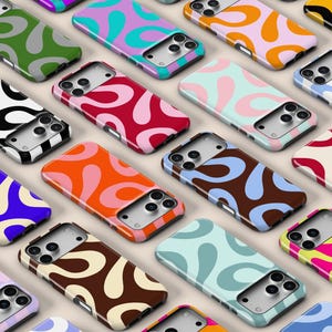 May include: A collection of smartphone cases arranged in a grid, each featuring a repeating abstract pattern of organic, teardrop-shaped blobs in various two-tone colour combinations, including red, orange, blue, green, pink, brown, and black.
